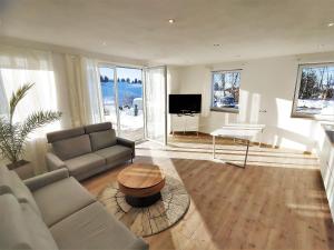 a living room with a couch and a table at Landhaus am Schindelberglift in Oberstaufen