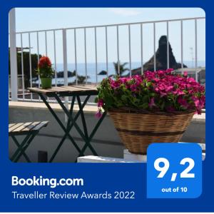 a basket of flowers sitting on a table on a balcony at Casa Vacanze Caramagna in Aci Castello