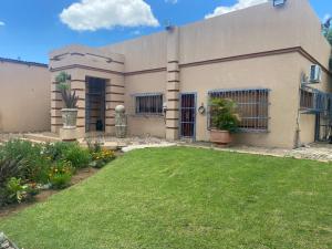 a house with a lawn in front of it at Magaliesberg inn in Rustenburg