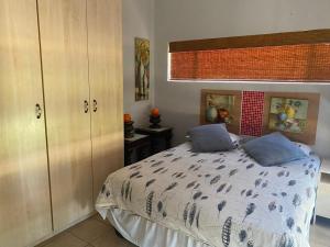 a bedroom with a bed with two pillows on it at Magaliesberg inn in Rustenburg