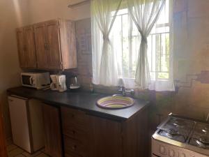 a kitchen with a counter top with a plate on it at Magaliesberg inn in Rustenburg +22 photos