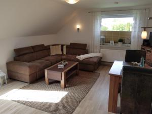 a living room with a couch and a coffee table at Ferienwohnung Am Lindenkrog in Rickert
