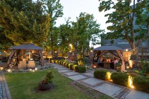 a garden with two gazebos and a restaurant at Villa Meduza in Kołobrzeg