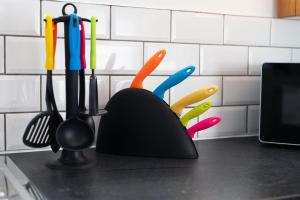 a kitchen counter with a bunch of kitchen utensils at The Nest - with Parking! in Swansea