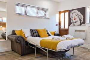 een slaapkamer met een bed met gele kussens bij The Nest - with Parking! in Swansea