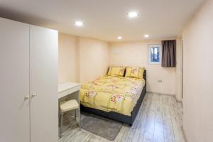 a small bedroom with a bed and a desk at Top Center Vintage Sofia Condo in Sofia
