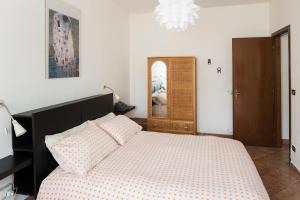 a bedroom with a bed and a chandelier at Alloggio turistico Giacomo Puccini in Viterbo