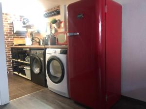 a red refrigerator in a kitchen with a washing machine at Top Center Vintage Sofia Condo in Sofia