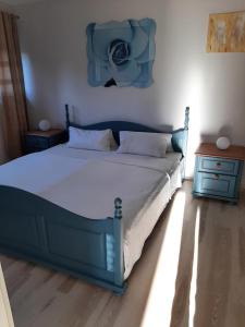 a bed in a bedroom with a blue bed frame at Ferienwohnung Waldblick in Hallenberg