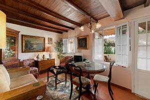 a living room with a table and chairs at Quinta Florença - By WeHost in Funchal