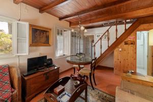 a living room with a staircase and a tv at Quinta Florença - By WeHost in Funchal