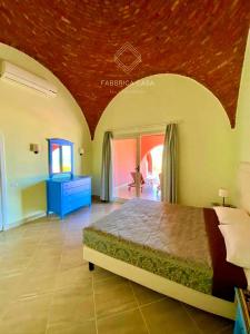 1 dormitorio con 1 cama grande y techo rojo en FabbricaCasa Sea Front Villa, Oriental Coast, en Marsa Alam