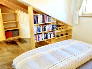 a bed in a room with a book shelf at Apartment Sonnenfeld in Samerberg