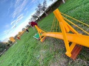 a man constructing a yellow swing set in a field at Quinta Alfaval in Redondo +104 photos