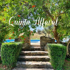 a stone path with a tree and a sign that reads cuitation alibal at Quinta Alfaval in Redondo