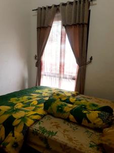 Ein Bett oder Betten in einem Zimmer der Unterkunft Villa FID Bandungan