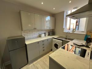 a kitchen with a sink and a dishwasher at Red Gables - Ground Floor in Carlisle