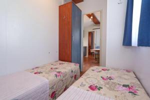 sypialnia z 2 łóżkami, szafką i lustrem w obiekcie Poolside Mobile Home w mieście Turanj