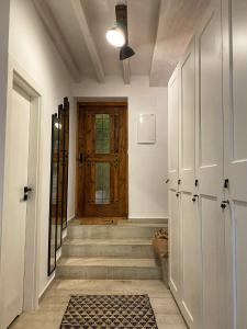 a hallway with a wooden door and a hallway with stairs at View 4 U Apartment - Alicante in Alicante