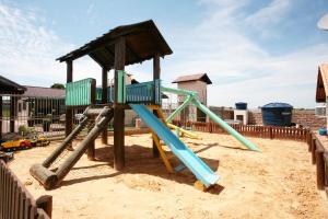 a playground with a slide in the sand at Cabanas Charme da Serra in Cambará