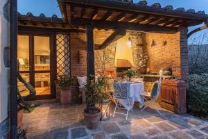 an outdoor dining area with a table and chairs at Rosyabate Cottage, with Private Garden and views between Lucca and Pistoia in Santa Lucia