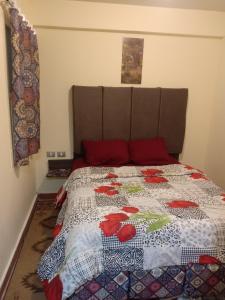 a bedroom with a bed with a quilt on it at One Bedroom Chalet at Porto South Beach Families only in Ain Sokhna