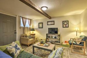 a living room with a couch and a table at Cozy and Vintage Cedar City Apartment with Fire Pit! in Cedar City