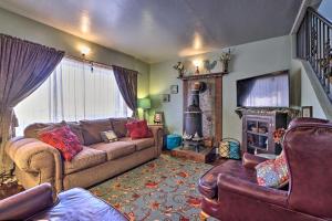 a living room with a couch and a fireplace at Charming Cedar City Retreat - Walk to Downtown! in Cedar City