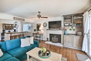 a living room with a blue couch and a fireplace at Sutter Creek Retreat with Patio Near Main St! in Sutter Creek