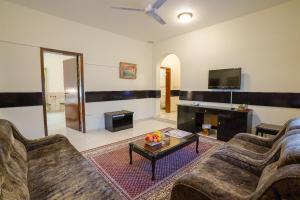 a living room with two couches and a coffee table at Hotel Summersands Al Wadi Al kabir in Muscat