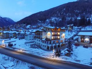 an aerial view of a town in the snow at night at Sport Hotel Stella Alpina in Cogolo