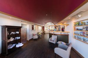 a large room with a bar in a store at Hotel Alter Kreisbahnhof in Schleswig