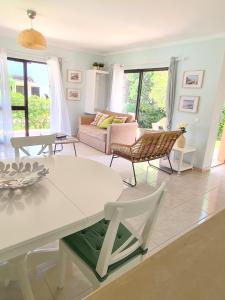 a living room with a white table and chairs at Algarve Apartment Falésia in Albufeira