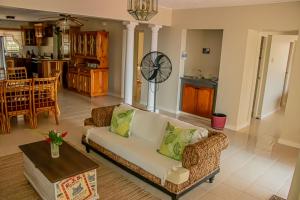 a living room with a couch and a table at The Whytehouse Villa in Montego Bay