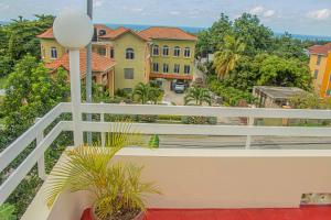 a balcony with a white railing and some buildings at The Whytehouse Villa in Montego Bay