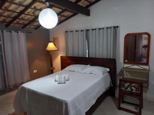 Ένα ή περισσότερα κρεβάτια σε δωμάτιο στο Ilha do Village