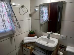 a bathroom with a sink and a mirror at Ilha do Village in Cabo Frio