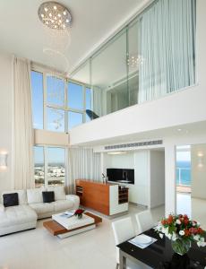 a living room with a couch and a table at Island Luxurious Suites Hotel and Spa- By Saida Hotels in Netanya