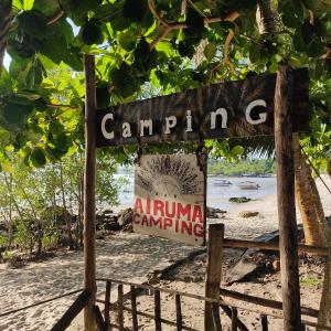 a sign for a camp on a beach at Camping Airuma in Ilha de Boipeba