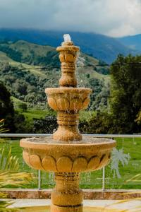 a stone fountain with water coming out of it at Hotel Boutique Palmas de Salento in Salento