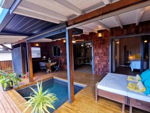 a patio with a bed and a swimming pool at EDEN FOREST Villas in Pointe-Noire