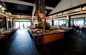 a dining room with tables and chairs in a restaurant at Strawberry Park Resort in Cameron Highlands