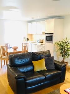a living room with a couch and a coffee table at My-Canning Street Apartments in Edinburgh