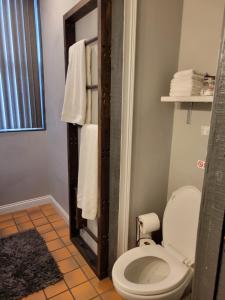 a bathroom with a toilet and towels at Modern style and comfort near UC in Cincinnati
