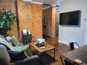 a living room with a couch and a table at Modern style and comfort near UC in Cincinnati