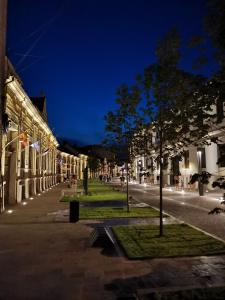 a city street at night with buildings and trees at Spiegel Center in Oradea