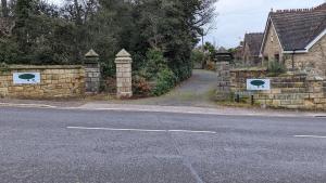 a street with a stone wall and a road at Summerfields House in Hastings