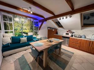a living room with a blue couch and a table at Comfort Zone Ostróda BLUE in Grabinek
