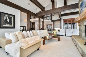a living room with a white couch and a fireplace at Deer Hollow Chalet in Park City