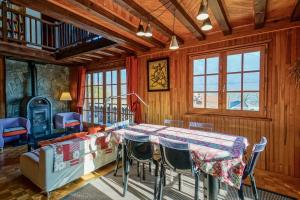 a dining room with a table and chairs at Le Chalet Soleil in Lathuile